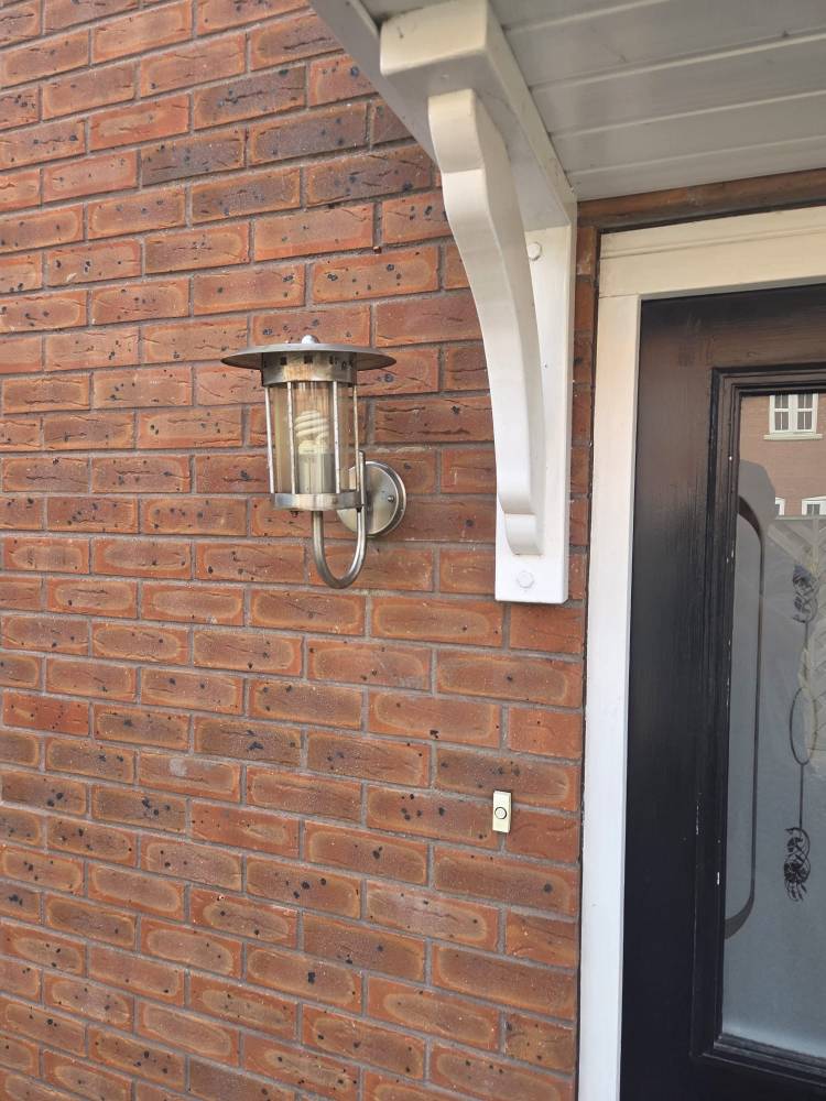 Porch light fitting on brick wall